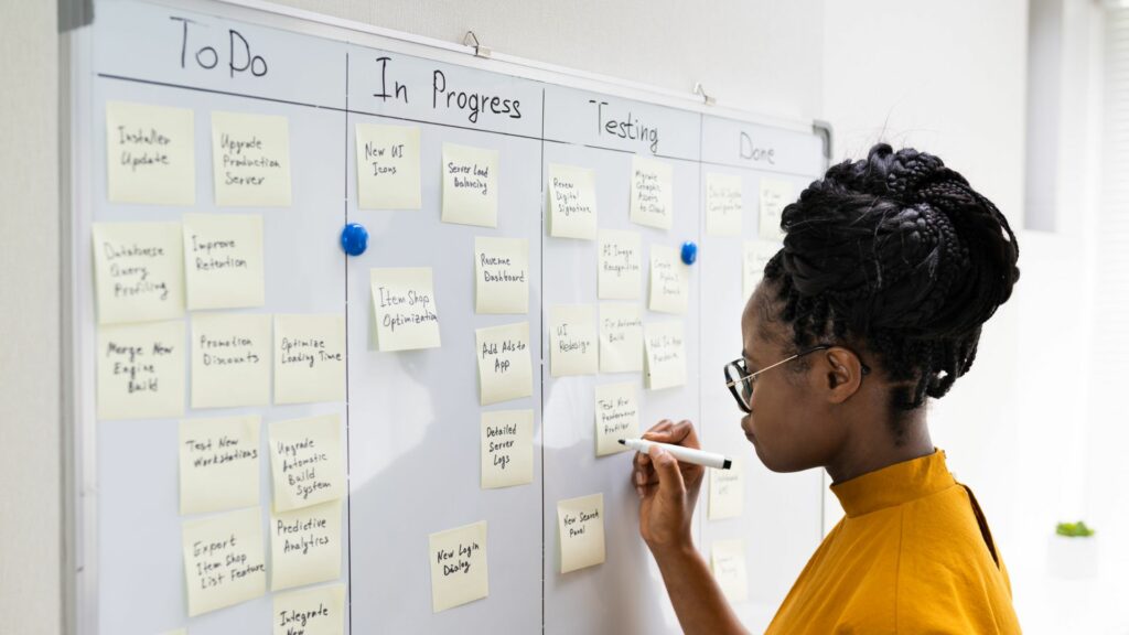 Girl working at a Kanban board.